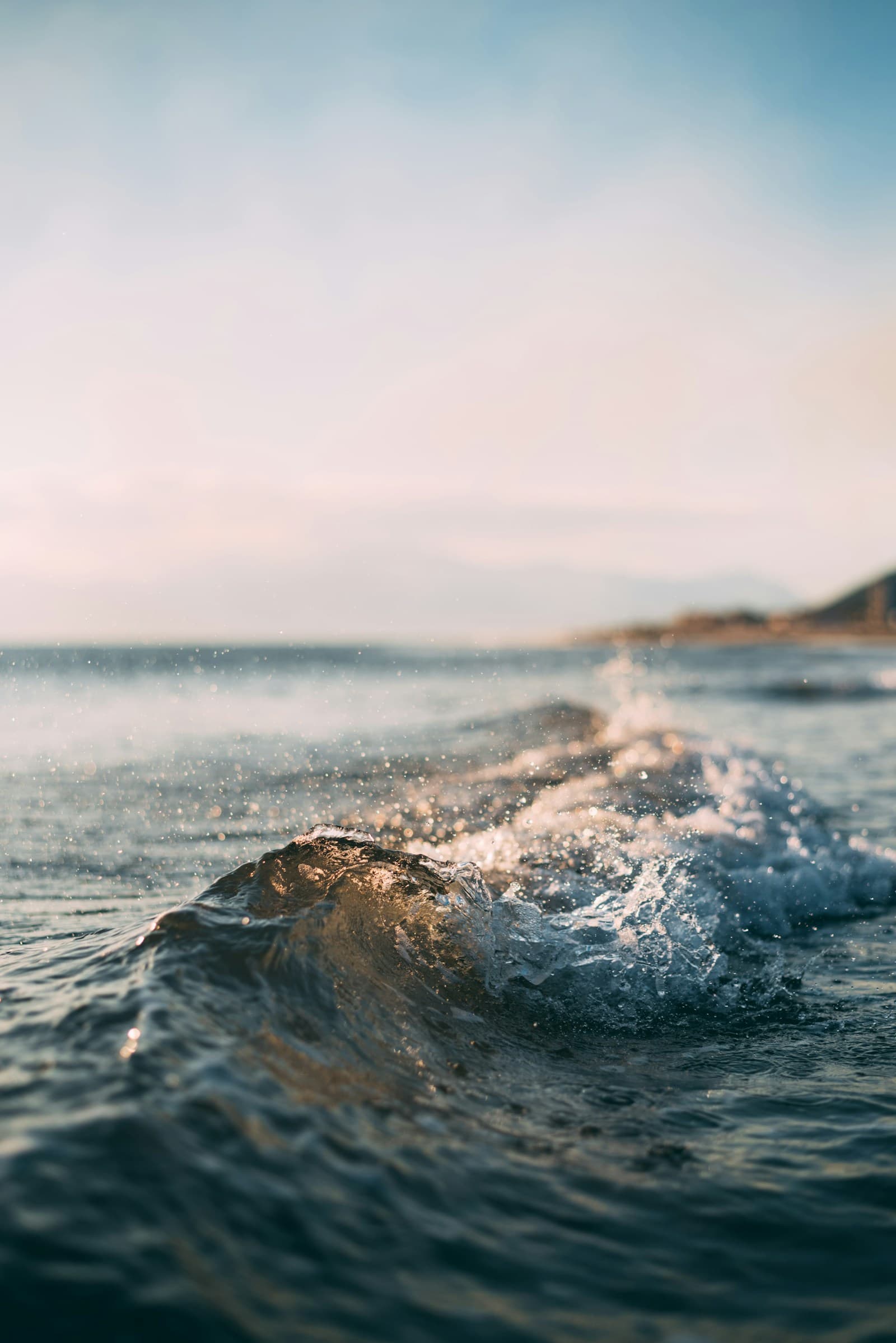 Waves rolling across the Pacific Ocean under a bright sky, used as editorial context for NOAA's El Niño advisory.