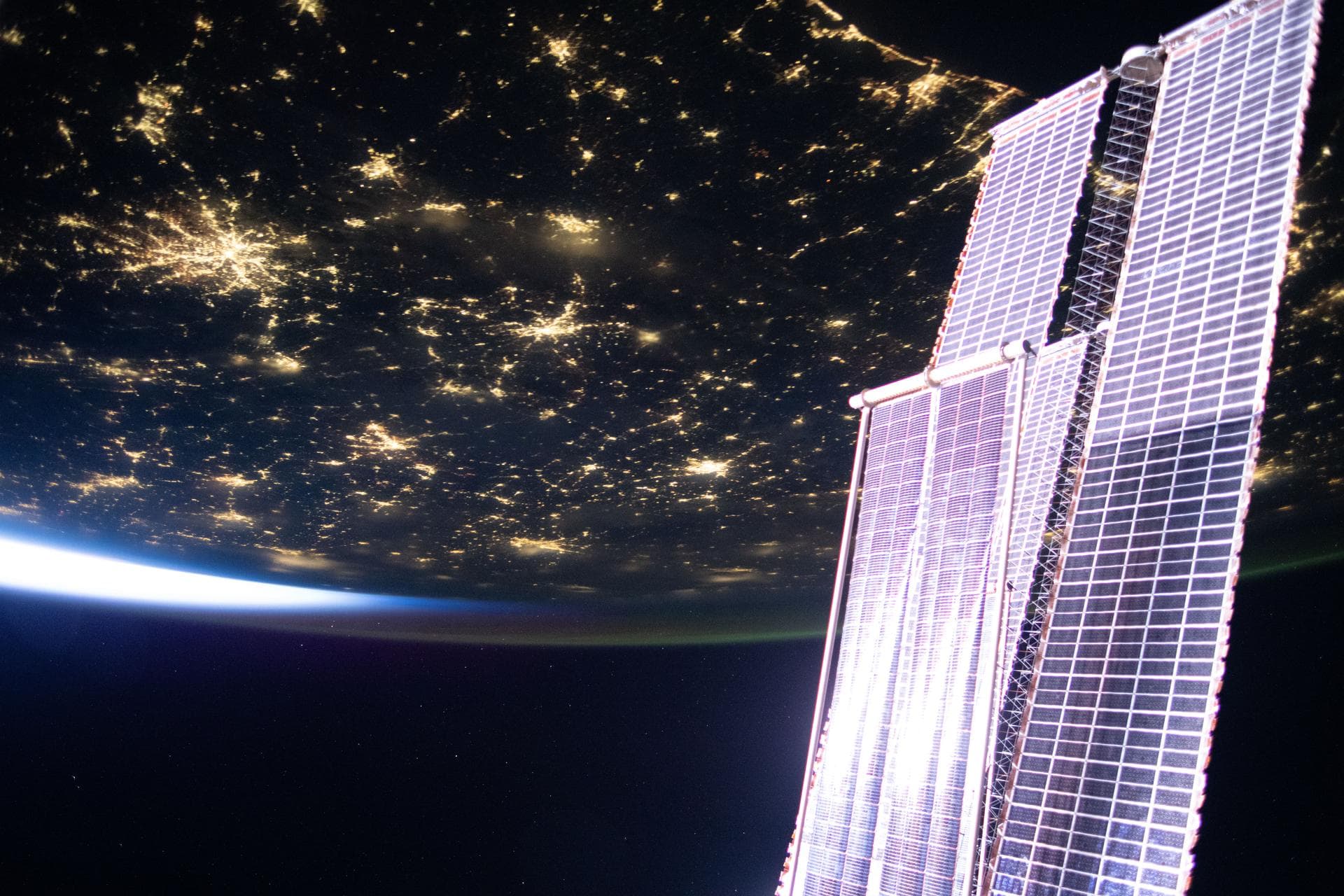 NASA file photograph showing the International Space Station's main and roll-out solar arrays above city lights in the southern United States