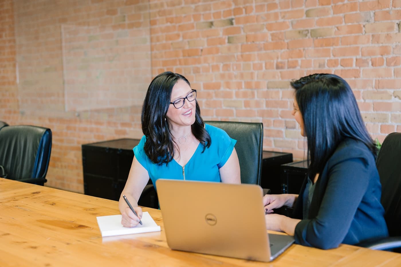 Illustrative photo of professionals reviewing hiring and business data in a meeting.