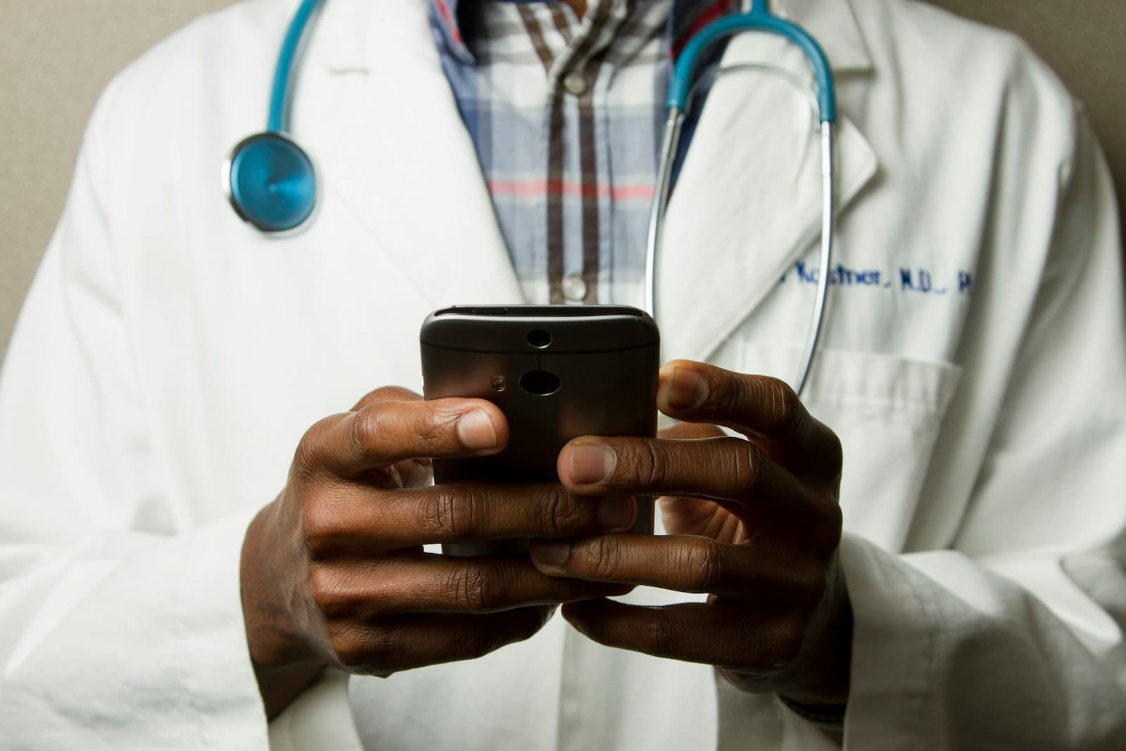 Clinicians reviewing public health information on a laptop, used as outbreak response imagery
