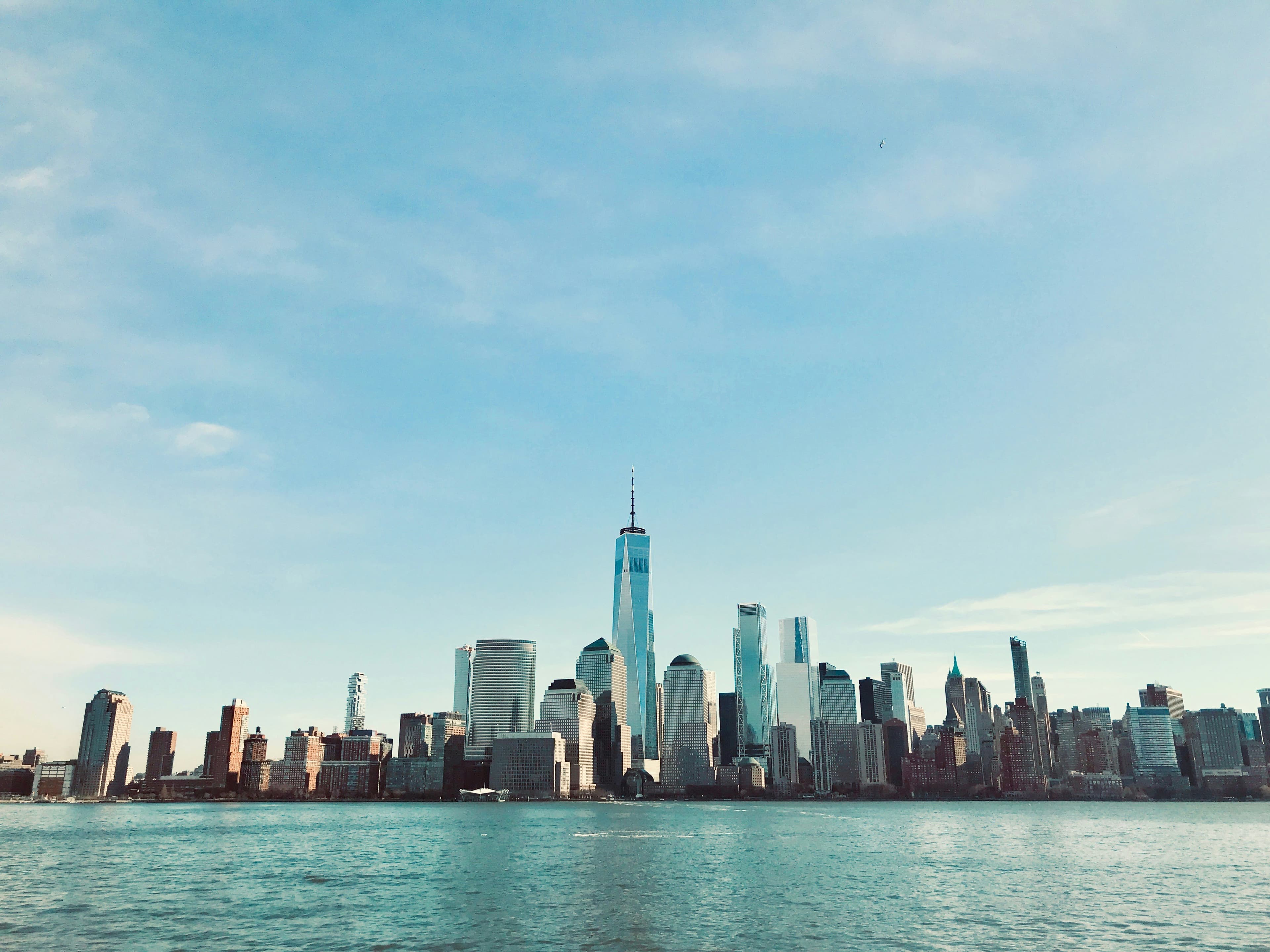 Lower Manhattan skyline viewed across the water during summer weather in New York City.