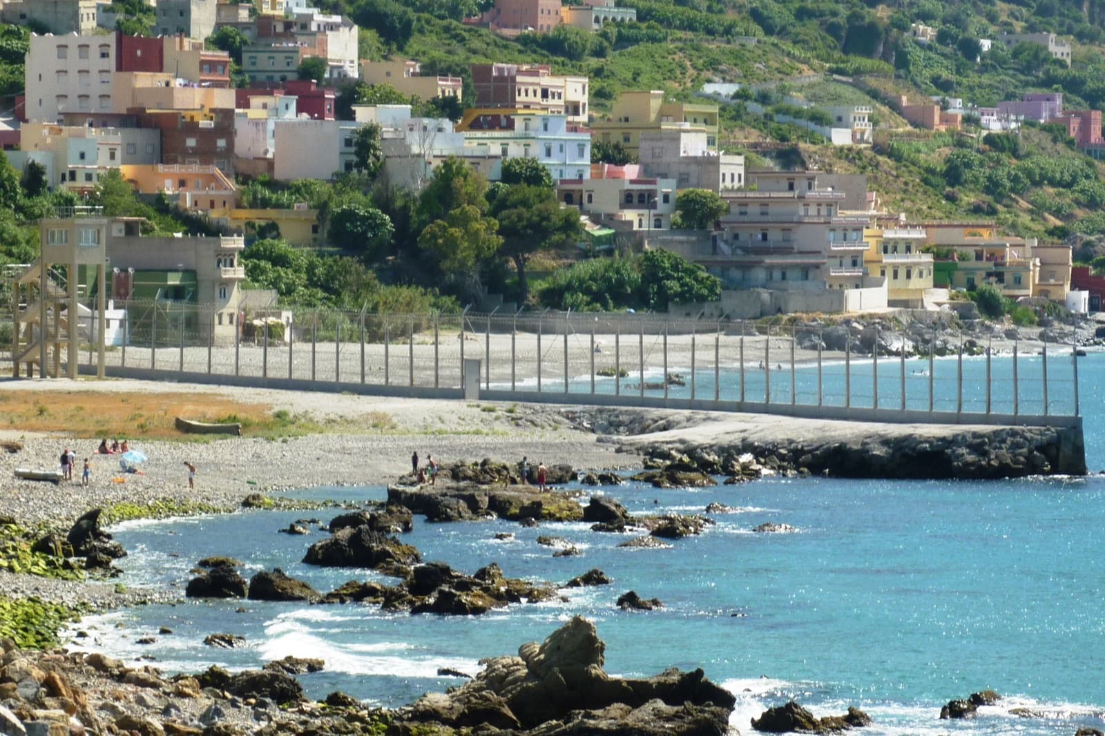 The coastal border fence separating Ceuta from Morocco beside the Mediterranean Sea